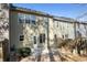 View of the backyard with a patio, door, and fence with some trees in the neighborhood at 145 Sunset Ln, Woodstock, GA 30189