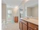 Bathroom featuring dual sink vanity, tub and shower combo, and window at 145 Sunset Ln, Woodstock, GA 30189