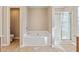 Bright bathroom featuring a soaking tub, shower, and a separate water closet at 145 Sunset Ln, Woodstock, GA 30189