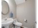 Powder room with pedestal sink and decorative mirror at 145 Sunset Ln, Woodstock, GA 30189