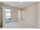 Bright bedroom featuring neutral walls, plush carpet, and a glass door leading to a balcony at 145 Sunset Ln, Woodstock, GA 30189