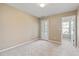 Carpeted bedroom with neutral walls and trim featuring a glass door leading to an outdoor space at 145 Sunset Ln, Woodstock, GA 30189