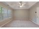 Empty bedroom featuring a ceiling fan, large window, neutral paint and carpeted floors at 145 Sunset Ln, Woodstock, GA 30189