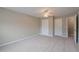 This large bedroom features carpeted floors and neutral paint, along with several doors at 145 Sunset Ln, Woodstock, GA 30189