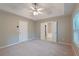 Neutral bedroom with tray ceiling, ceiling fan, and ensuite bathroom with soaking tub at 145 Sunset Ln, Woodstock, GA 30189