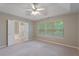 Neutral bedroom with tray ceiling, ceiling fan, and ensuite bathroom with shower at 145 Sunset Ln, Woodstock, GA 30189
