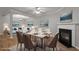 Elegant dining area with a fireplace, mountain view paintings, and hardwood flooring at 145 Sunset Ln, Woodstock, GA 30189