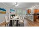 Bright dining room with a modern table set, hardwood floors, and a view to the kitchen at 145 Sunset Ln, Woodstock, GA 30189