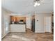 View of the kitchen from the living room, stainless steel refrigerator, and wood cabinets at 145 Sunset Ln, Woodstock, GA 30189