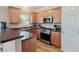 Well-equipped kitchen featuring wooden cabinets, stainless steel appliances, and a functional design at 145 Sunset Ln, Woodstock, GA 30189