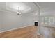 Spacious living area with a fireplace, hardwood floors, and large windows for natural light at 145 Sunset Ln, Woodstock, GA 30189