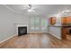 Spacious living room with hardwood floors, fireplace, and open access to the kitchen at 145 Sunset Ln, Woodstock, GA 30189