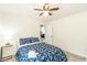 Cozy bedroom with a ceiling fan, luxury vinyl plank flooring, and a bed with blue floral bedding at 299 Fletcher Street Sw, Atlanta, GA 30315