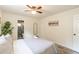 Bedroom with ceiling fan and view into a full ensuite bathroom with glass enclosed shower at 299 Fletcher Street Sw, Atlanta, GA 30315