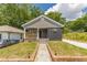 Charming renovated bungalow with gray siding, black brick accents, and well maintained lawn at 299 Fletcher Street Sw, Atlanta, GA 30315