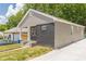 Angled view of the home highlighting the gray siding, black brick, and charming front porch at 299 Fletcher Street Sw, Atlanta, GA 30315