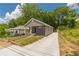 Charming renovated bungalow with gray siding, black brick accents, and freshly poured driveway at 299 Fletcher Street Sw, Atlanta, GA 30315