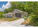 Charming renovated bungalow with gray siding, black brick accents, and freshly poured driveway at 299 Fletcher Street Sw, Atlanta, GA 30315