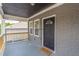 Inviting front porch with a welcoming entrance door and freshly painted gray brick and trim at 299 Fletcher Street Sw, Atlanta, GA 30315