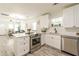 Bright kitchen with stainless steel appliances and an island overlooking an open floor plan at 299 Fletcher Street Sw, Atlanta, GA 30315