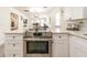 Open concept kitchen with stainless steel oven range and quartz countertops overlooks the dining and living areas at 299 Fletcher Street Sw, Atlanta, GA 30315