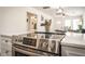 Open concept kitchen with stainless steel oven range and quartz countertops overlooks the dining and living areas at 299 Fletcher Street Sw, Atlanta, GA 30315