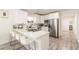 Modern kitchen with sleek white cabinets, stainless steel appliances and bar stool seating at the counter at 299 Fletcher Street Sw, Atlanta, GA 30315