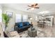 Open-concept living room with kitchen and dining area featuring modern decor and ample natural light at 299 Fletcher Street Sw, Atlanta, GA 30315