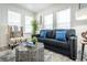 Cozy living room with a dark sofa, patterned chair, decorative pillows, and a stylish accent table at 299 Fletcher Street Sw, Atlanta, GA 30315