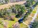 Aerial view of house with a dark roof, surrounded by trees, and nearby roadway at 5042 Central Church Rd, Douglasville, GA 30135