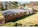 Rear exterior view of brick home featuring a large yard, patio area, and visible AC unit at 5042 Central Church Rd, Douglasville, GA 30135