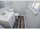 A bathroom with a white vanity and luxury vinyl flooring at 5042 Central Church Rd, Douglasville, GA 30135