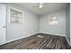 This bedroom has luxury vinyl flooring and two windows at 5042 Central Church Rd, Douglasville, GA 30135