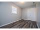 Bedroom featuring hardwood floors, closet, and a bright window at 5042 Central Church Rd, Douglasville, GA 30135