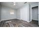 A bright bedroom featuring luxury vinyl flooring and a window at 5042 Central Church Rd, Douglasville, GA 30135