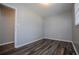 Bedroom with hardwood floors and neutral paint providing a calming space at 5042 Central Church Rd, Douglasville, GA 30135