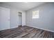 A spacious bedroom features luxury vinyl flooring and a closet at 5042 Central Church Rd, Douglasville, GA 30135