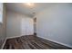 Bedroom featuring hardwood floors, closet, and neutral paint providing a calming space at 5042 Central Church Rd, Douglasville, GA 30135