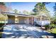 Single-story brick home with attached carport, covered porch, and a well manicured lawn at 5042 Central Church Rd, Douglasville, GA 30135