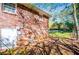 Brick house exterior showcasing windows and utility connections along the side of the home at 5042 Central Church Rd, Douglasville, GA 30135