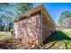 Exterior of brick home with view of the yard, windows, and utility connections at 5042 Central Church Rd, Douglasville, GA 30135