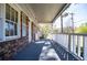 View of the long front porch with white railing and shuttered windows at 5042 Central Church Rd, Douglasville, GA 30135