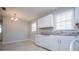 This kitchen boasts a dining nook with chandelier and granite countertops at 5042 Central Church Rd, Douglasville, GA 30135