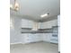 Well-lit kitchen featuring white cabinetry, updated appliances, and ample countertop space for cooking at 5042 Central Church Rd, Douglasville, GA 30135