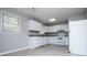 Bright kitchen features white cabinets, gray countertops, and ample natural light from the window at 5042 Central Church Rd, Douglasville, GA 30135