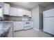 Close-up of kitchen with white cabinets, gray countertop, and modern appliances at 5042 Central Church Rd, Douglasville, GA 30135