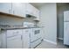 Modern kitchen with white cabinets, updated countertops, and a full suite of appliances for the home chef at 5042 Central Church Rd, Douglasville, GA 30135