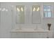 Bright bathroom with white subway tile, double sinks, and updated light fixtures at 81 Delmont Ne Dr, Atlanta, GA 30305