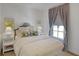 Cozy bedroom with a plush bed, decorative pillows, and natural light from the window at 81 Delmont Ne Dr, Atlanta, GA 30305