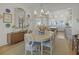 Bright dining area features a round table, chandelier, and a view into the modern kitchen at 81 Delmont Ne Dr, Atlanta, GA 30305